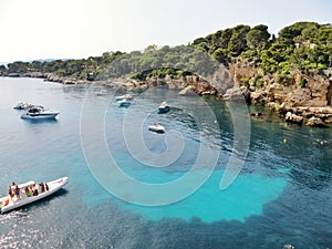 Cap d& x27;Antibes billionaire beach with trees, rocks and yachts