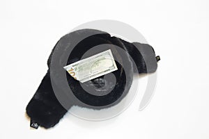 A cap with earflaps on a white background, in a cap of 100 dollars