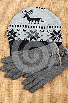 Cap and gloves isolated on linen background.