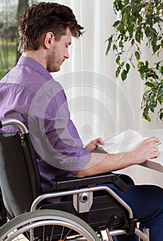 Capable disabled man reading a book