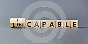 Capable or incapable symbol. Concept words Capable or Incapable on wooden cubes. Beautiful grey table grey background. Business