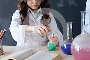 Capable teenagers taking part in the chemistry experiment at school