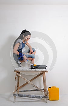 Capable woman painting the wall of her house