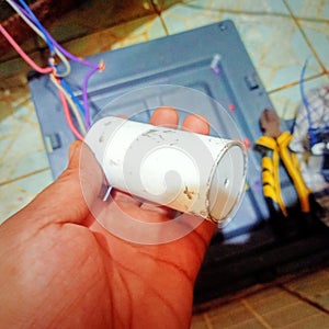 The capacitor in the washing machine is to provide additional electrical power so that the dynamo can rotate