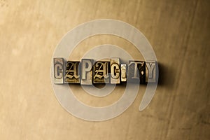 CAPACITY - close-up of grungy vintage typeset word on metal backdrop