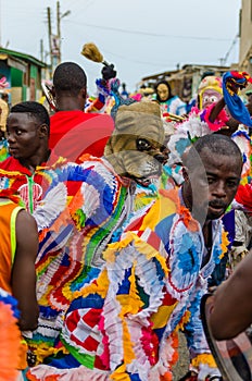 Cape Coast, Ghana - February 15, 2014: Colorful masked and costumed dancers during African carnival festivities