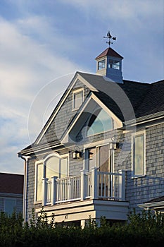 Sailboat windvane atop a balconied second floor