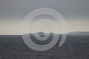 Cape Crillon of Sakhalin Island in fog. Lighthouse Crillon. Sakhalin Island, La Perouse Strait, The Sea of Okhotsk, Russia.