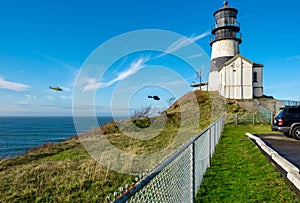 Cape Disappointment Lighthouse. Coast guard helicopters in the sky.
