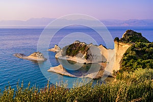 Cape Drastis at sunset close to Peroulades and Sidari village - Beautiful coast scenery with High cliffs and paradise beach -