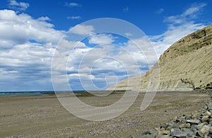 Cape with gray cliffs in the ocean