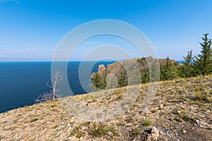 Cape Khoboy surrounded by the turquoise water of Lake Baikal is the northernmost point of Olkhon Island. Place of power in local