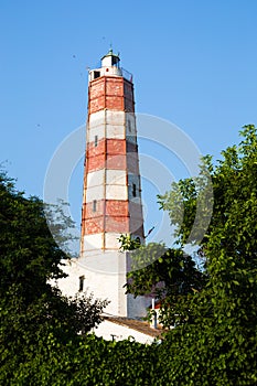 The Cape Shabla lighthouse framed by trees photo