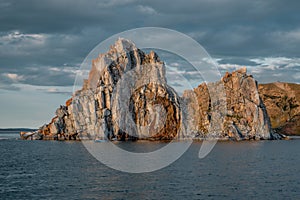 Cape Shamanka rock in Lake Baikal, background clouds, sunset light