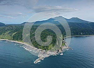 Cape Stolbchaty and Mendeleev Volcano on Background, Kunashir island photo