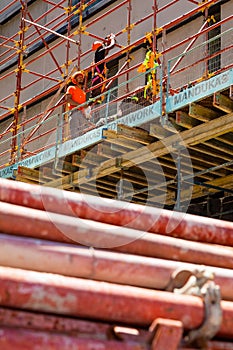 Construction workers on scaffolding on building site