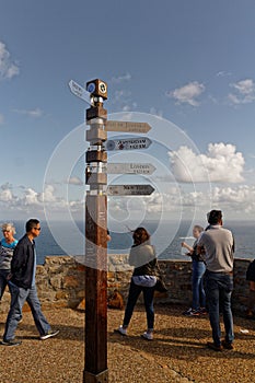 Cape town,South-Africa,Nov,13,2015:Cities signpost distance pole. Cape of Good Hope, with tourists, blue sky and ocean