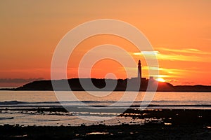 Cape Trafalgar Lighthouse and sunset, Spain photo
