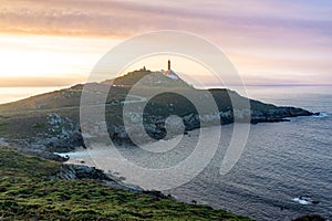 Cape Vilan Lighthouse, Cabo Vilano, in Galicia at sunset, Spain photo