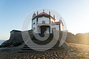 Capela do Senhor da Pedra or Lord of the rock chapel at sunset, Miramar, Portugal