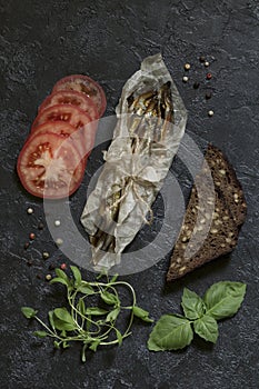 Capelin cold smoked fish wrapped in parchment and tied with a la