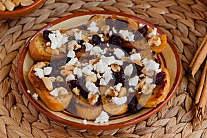 Capirotada on a traditional clay plate. Mexican gastronomy