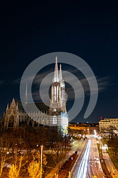 Capital of Austria Vienna at night, view on gothic church and streets of the city