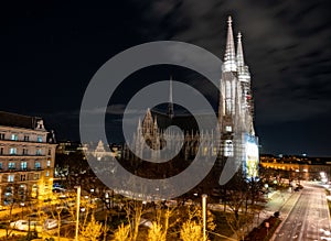 Capital of Austria Vienna at night, view on gothic church and streets of the city