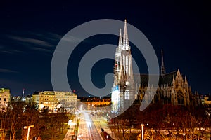 Capital of Austria Vienna at night, view on gothic church and streets of the city