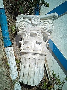 Capital, crowning part of an ancient antique column or pilaster, lying on the street as an element of street decor