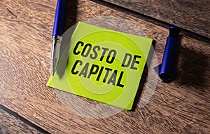 CAPITAL EXPENDITURE text on clipboard with keyboard on wooden background