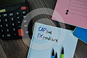 Capital Expenditure write on a book isolated on office desk photo