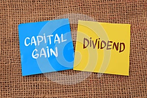 Capital gain and dividend, text words typography written on paper, life and business motivational inspirational concept