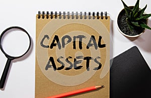 Capital gains - increase in a capital asset's value and is realized when the asset is sold, text concept on notepad