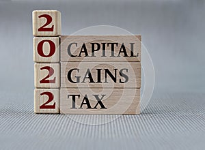 CAPITAL GAINS TAX 2022 - words on wooden blocks on gray background