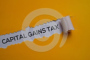 Capital Gains Tax Text written in torn paper