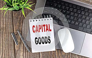 CAPITAL GOODS text on notebook with laptop, mouse and pen