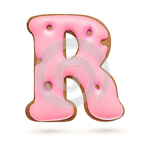 Capital letter R. Pink gingerbread biscuit isolated on white