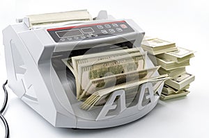 Capitalism, economic wealth and value investing conceptual idea with 100 dollar bills counted in money counting machine next to