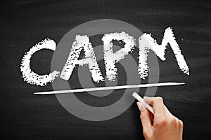CAPM Capital Asset Pricing Model - relationship between systematic risk and expected return for assets, acronym text on blackboard photo