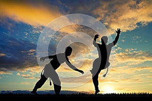 Capoeira dance at sunset