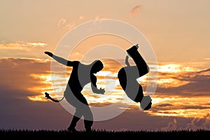 Capoeira dance at sunset