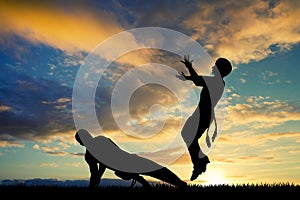 Capoeira dance at sunset