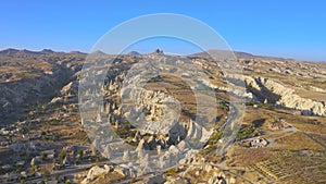 Cappadocia aerial drone view sandy volcanic formations and the road leading to the Uchisar Castle. Kayseri, Cappadocia