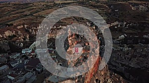 Cappadocia, Aerial View of Mountain Ortahisar Castle With Caves And Turkish Flag