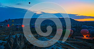 Cappadocia, Goreme, Anatolia, Turkey. Hot air balloons floating in the sky with backlit colorful background behind