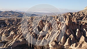 Cappadocia rock cave with rock carvings near the city of GÃ¶reme with snow during winter in central Turkey.