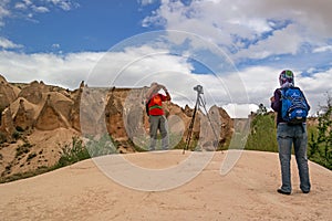 Cappadocia, Turkey - April 29, 2014: Stone columns Red Valley. Tourists are photographed on a background of geological formations