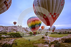 Cappadocia, Turkey - JUNE 01,2018: Festival of Balloons. Flight on a colorful balloon between Europe and Asia. Fulfillment of desi