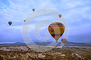 Cappadocia, Turkey - JUNE 01,2018: Festival of Balloons. Flight on a colorful balloon between Europe and Asia. Fulfillment of desi